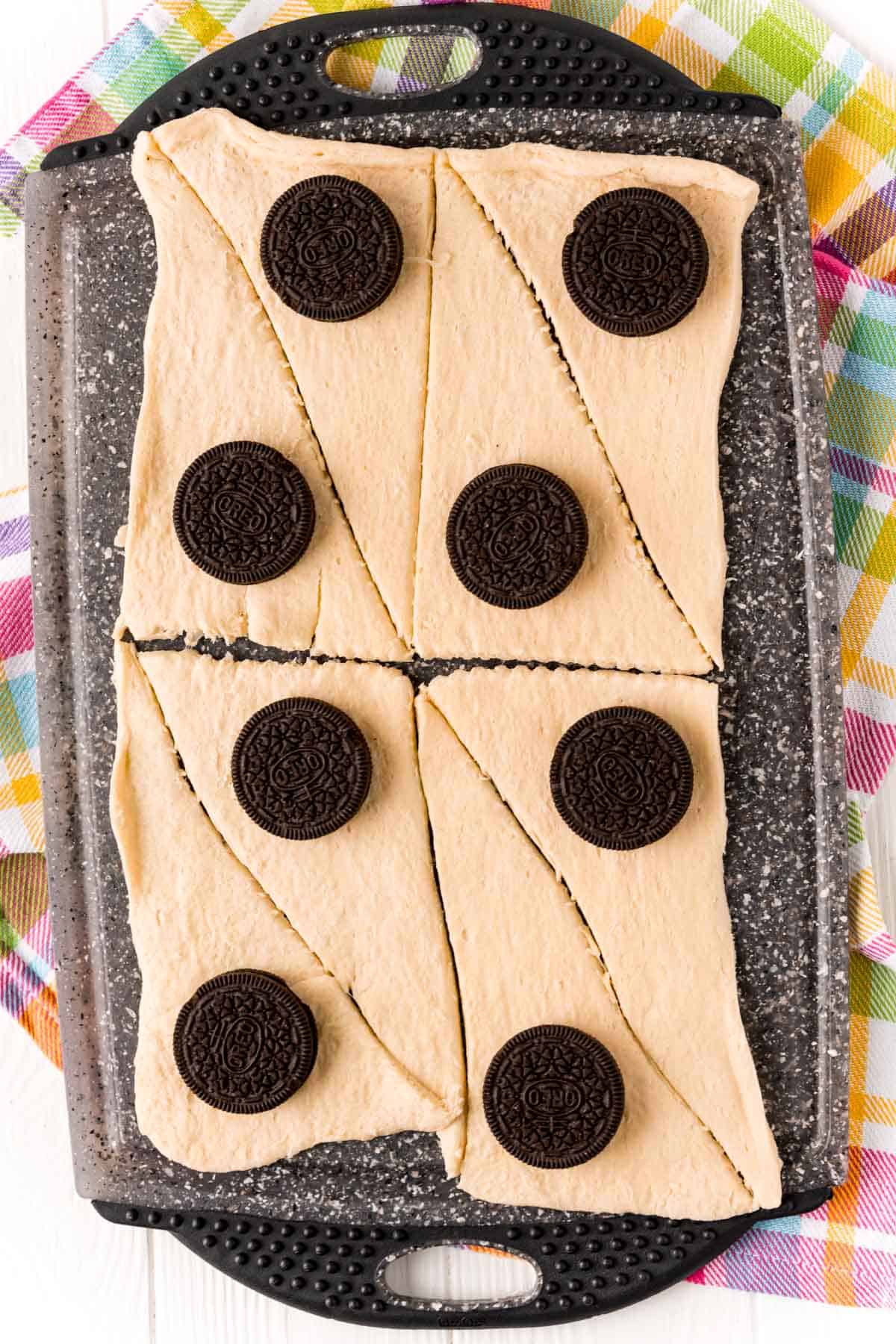 Oreos laid on top of crescent roll triangles.