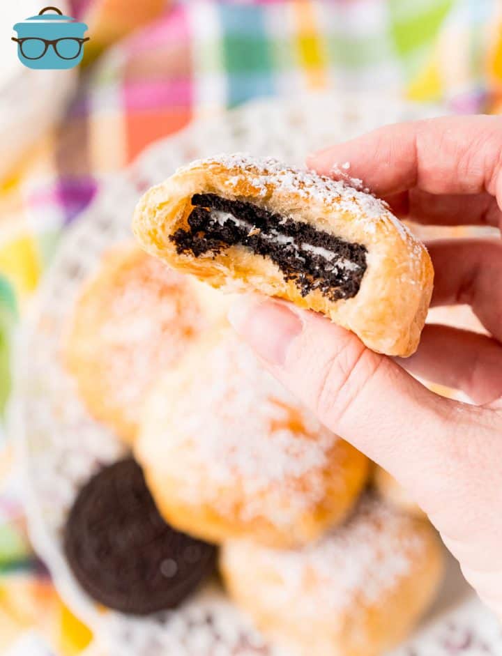 Hand holding up on Air Fried Oreo with bite taken out.