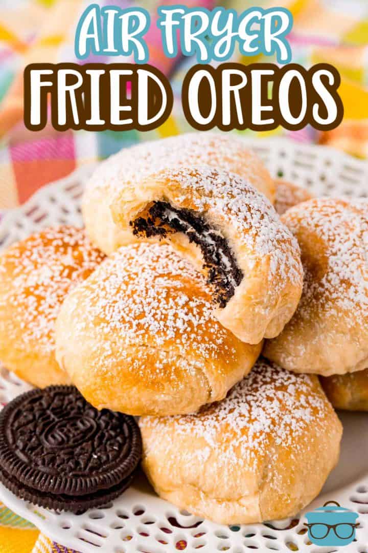 Air Fryer Fried Oreos close up stacked with bite taken out of top one .