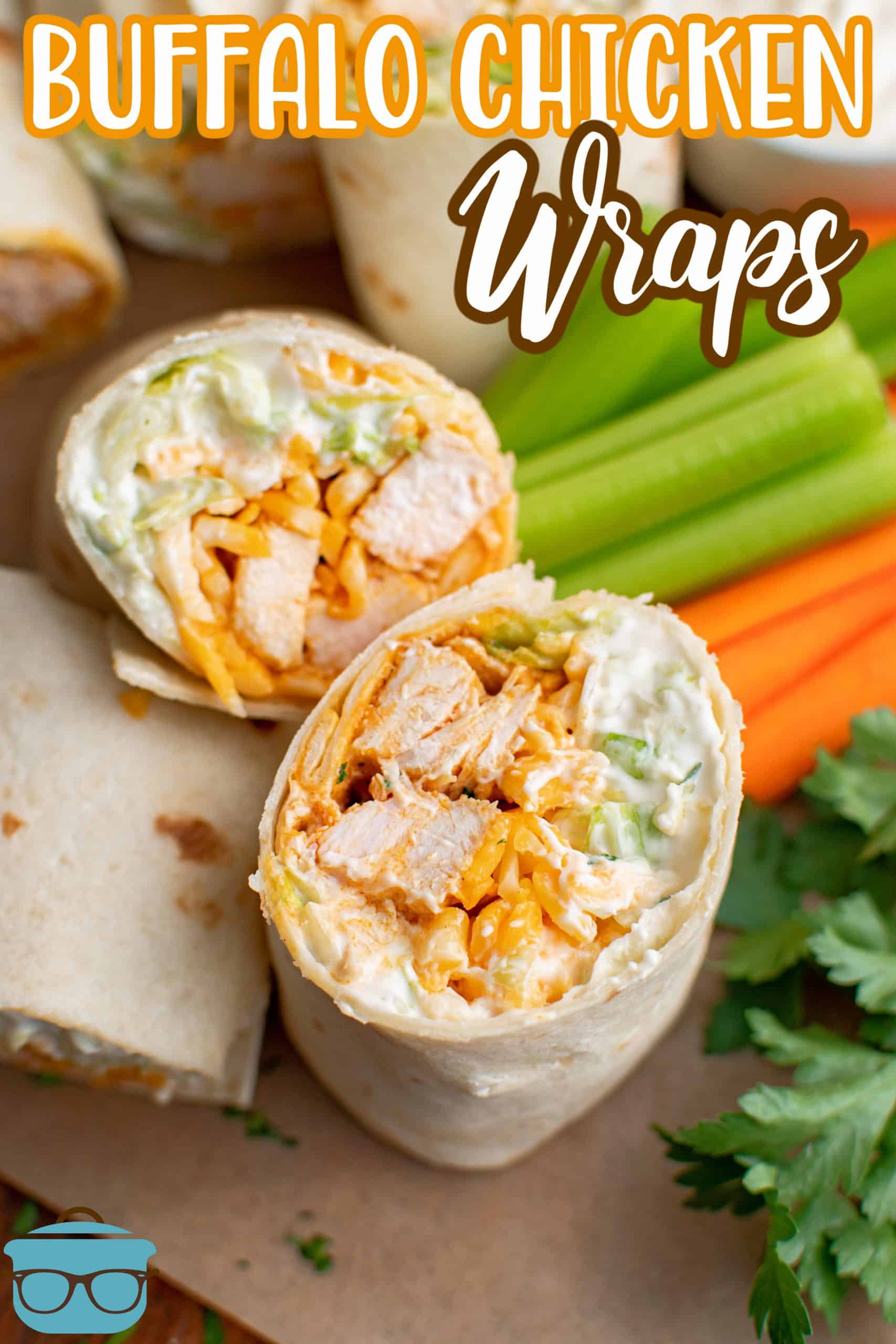 One cut open Buffalo Chicken wrap next to carrots and celery.