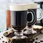 Old-Fashioned Irish Coffee on platter with coffee beans square image