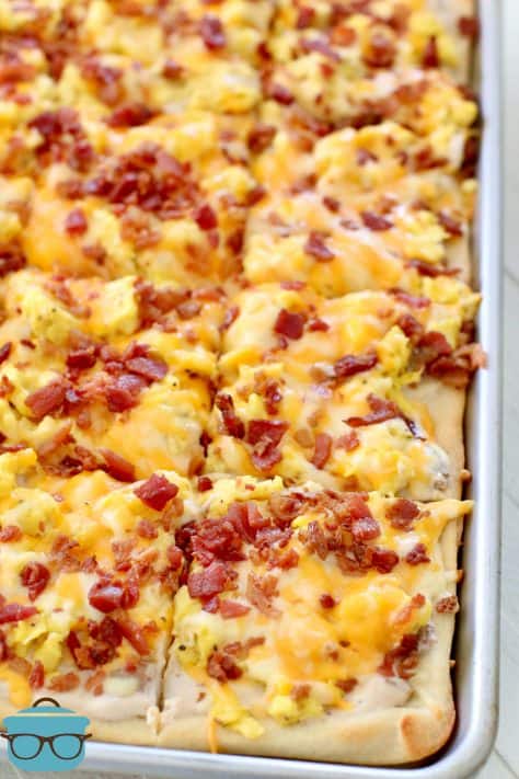 Fully cooked Breakfast Pizza shown sliced into squares in baking pan