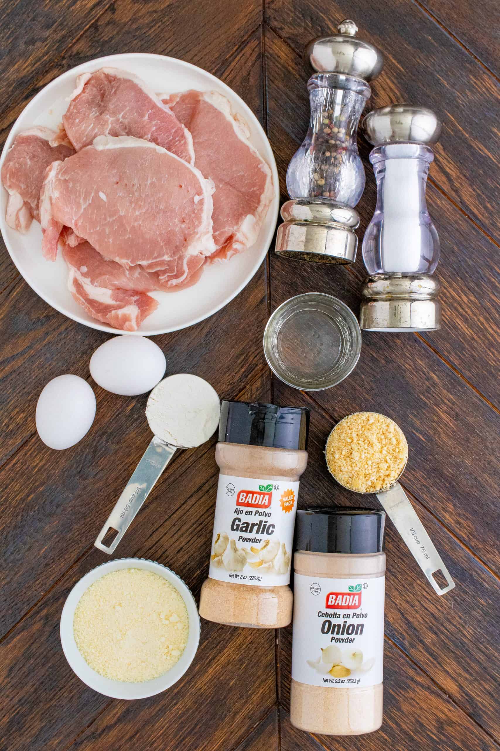 Ingredients needed to make Air Fryer Pork Chops: all-purpose flour, salt and pepper, thin-cut boneless pork chops, eggs, water, club crackers, parmesan cheese, garlic powder, onion powder.