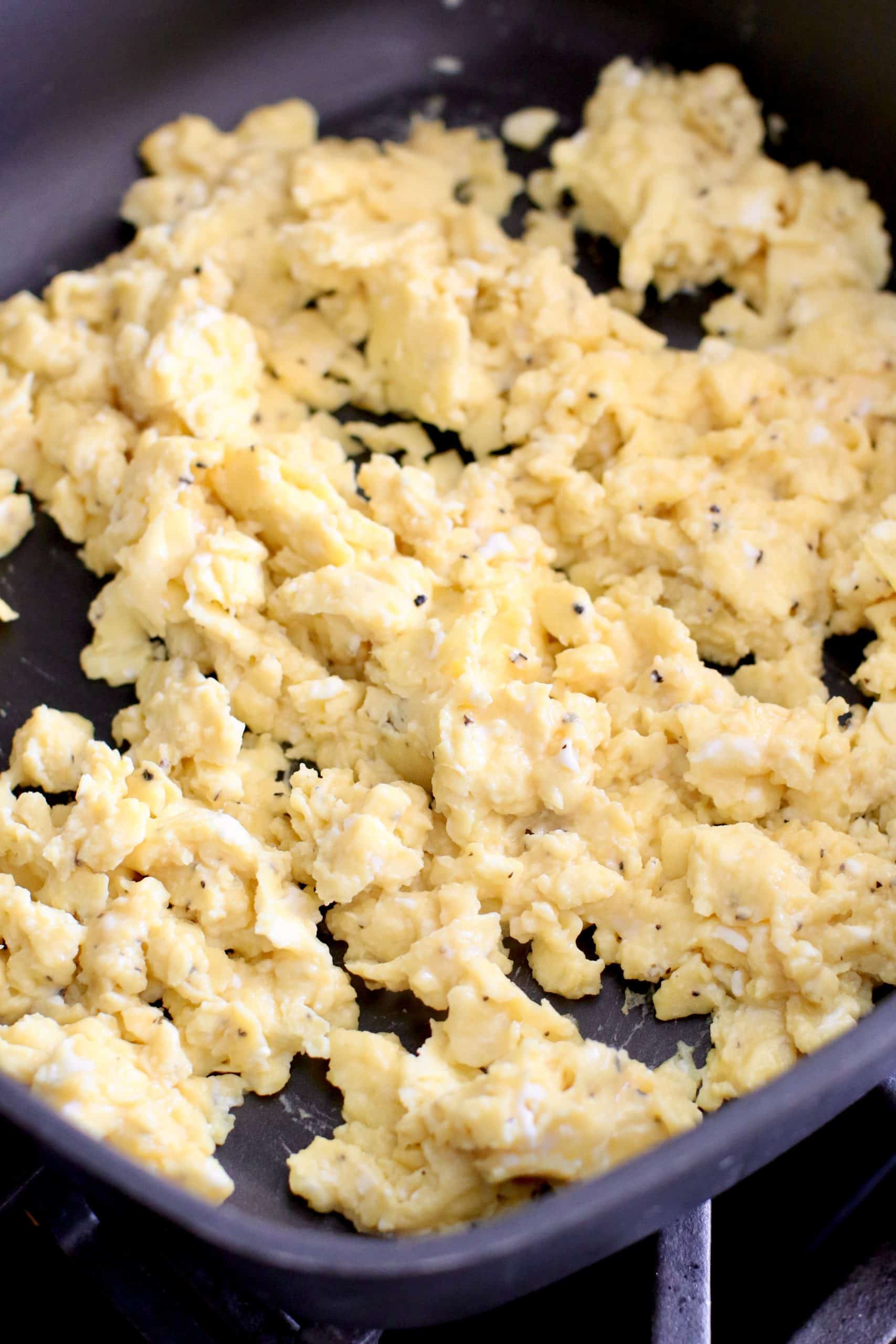 scrambled eggs shown in a large skillet.