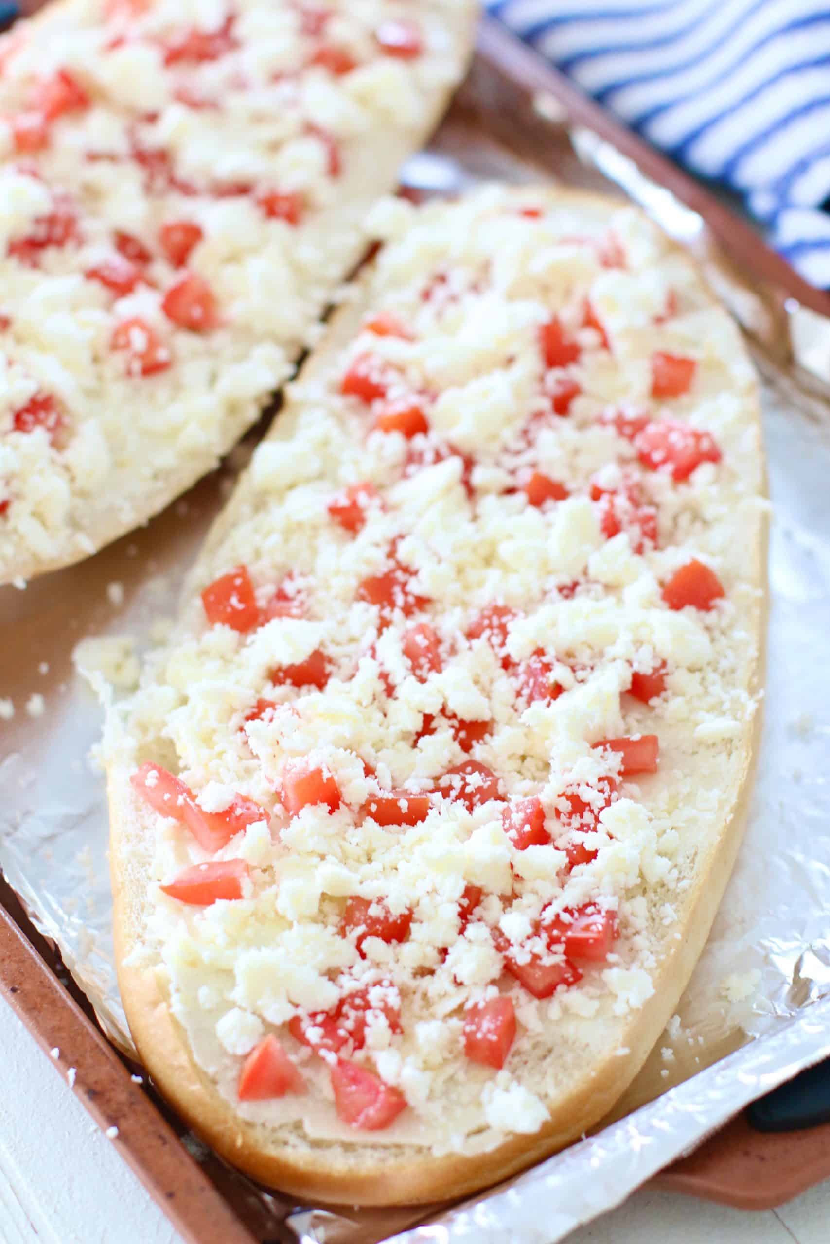 crumbled queso fresco sprinkled evenly on diced tomato layer.