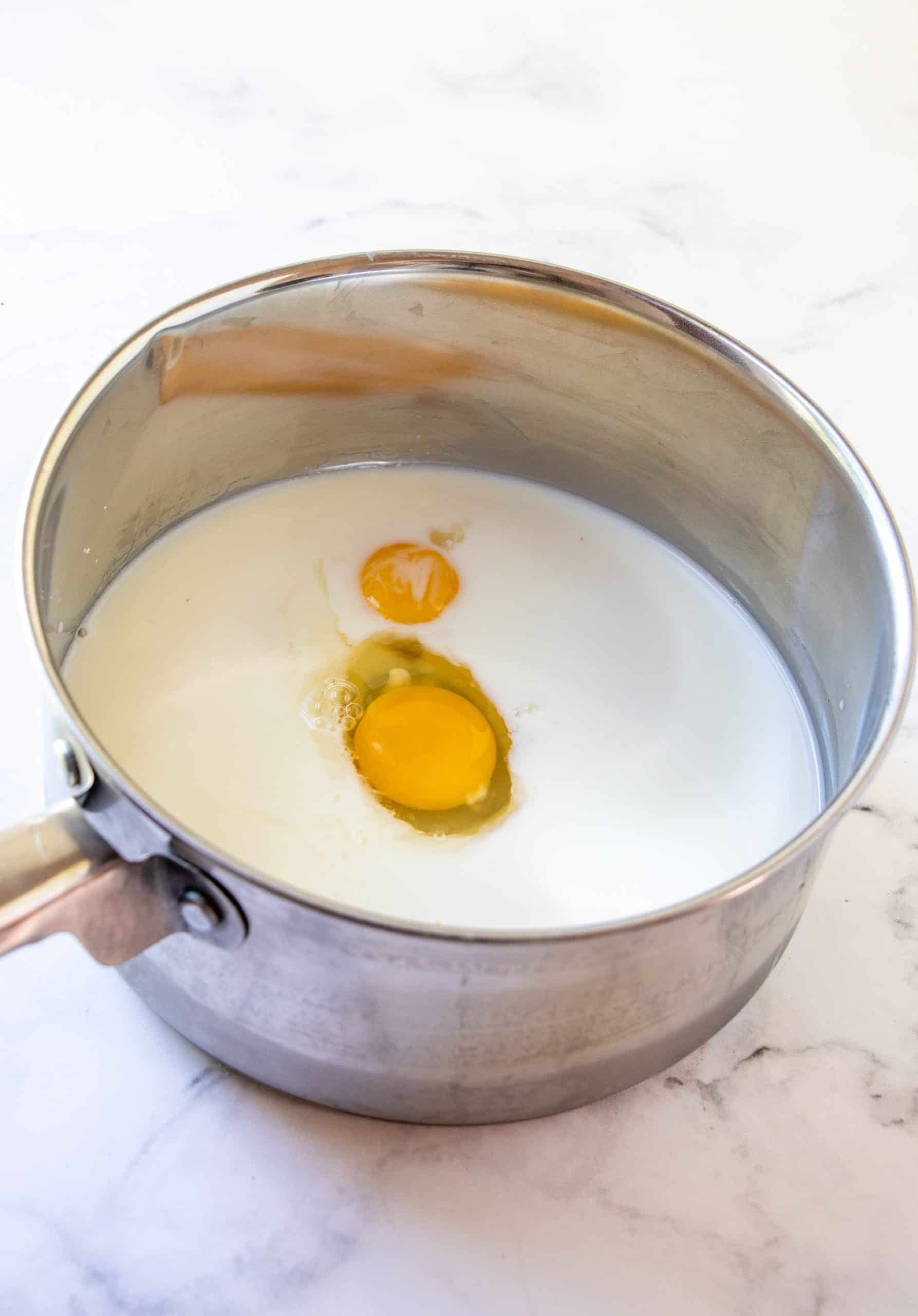 Milk, sugar, cornstarch, salt, egg and egg yolk adding to pan.
