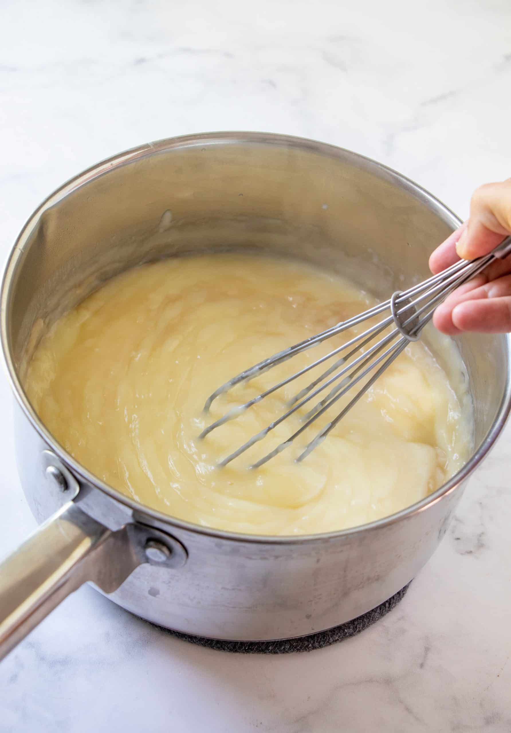 Whisk mixing vanilla and butter into pudding mixture.