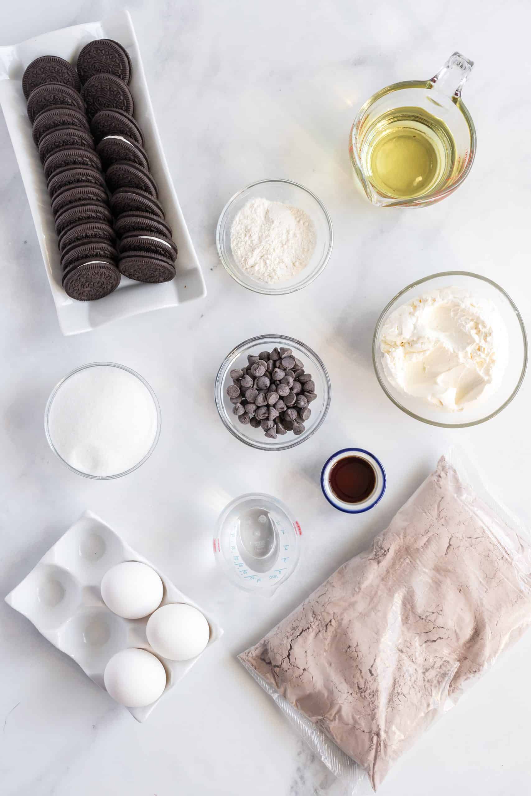 Ingredients needed brownie mix, oreos, cream cheese, sugar, vanilla extract, egg, all-purpose flour and chocolate chips.