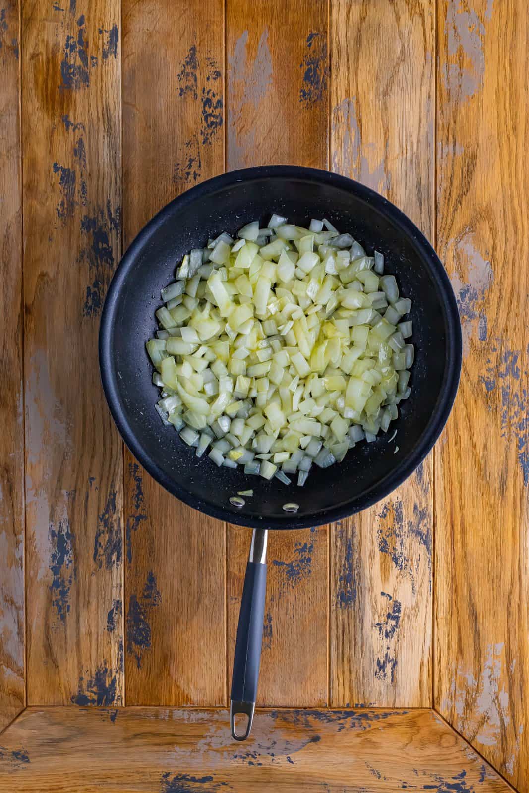 diced onions cooking in olive oil in a large skillet. 