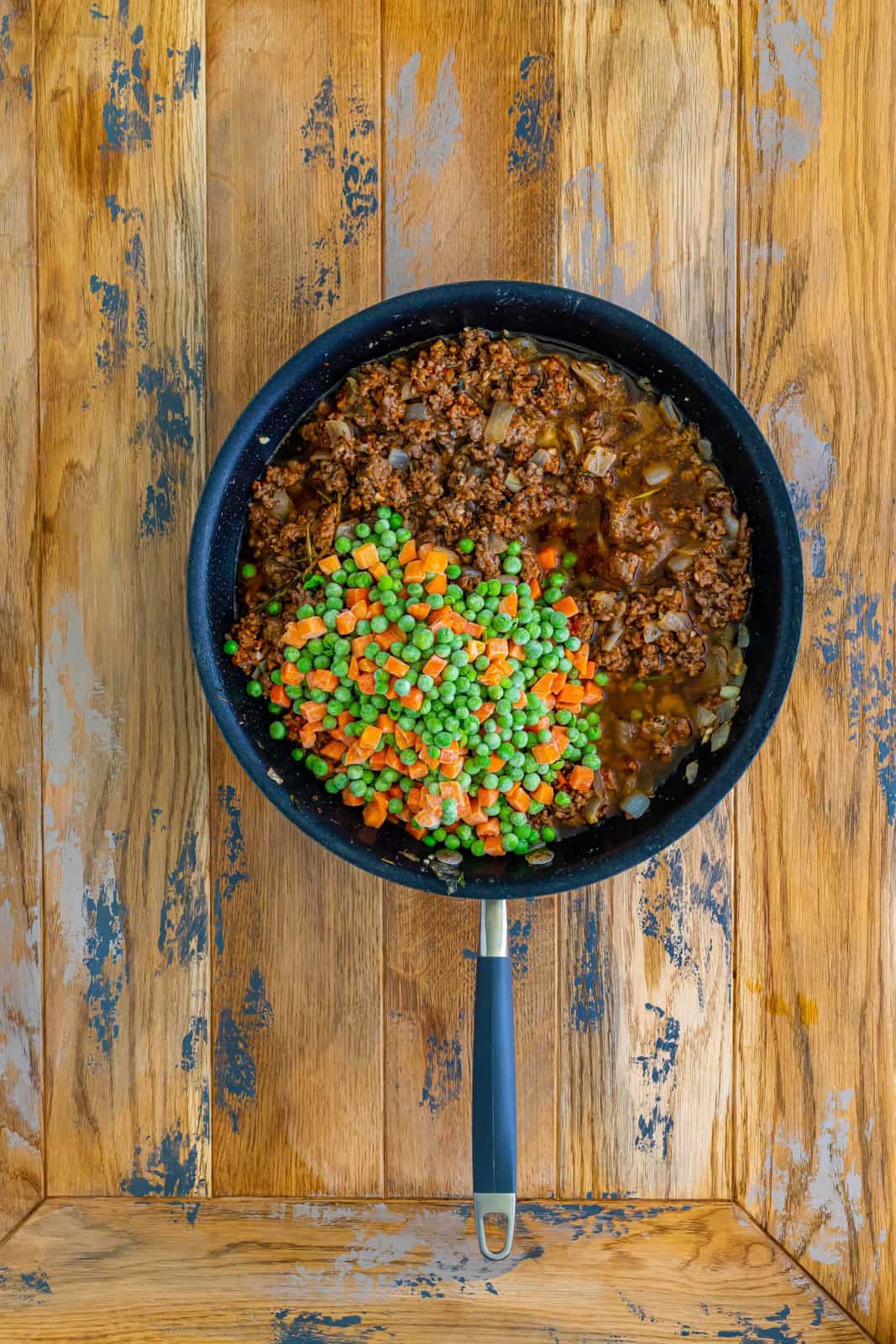 frozen peas and carrots and beef broth added to the skillet with the beef mixture. 