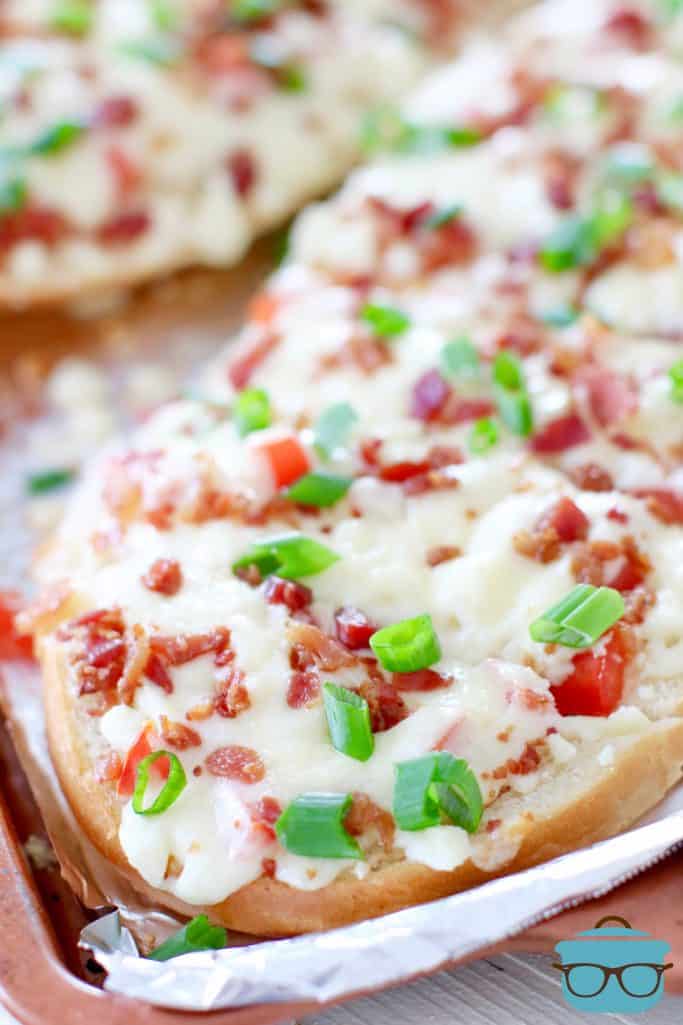 cheesy bread with bacon shown on a baking sheet
