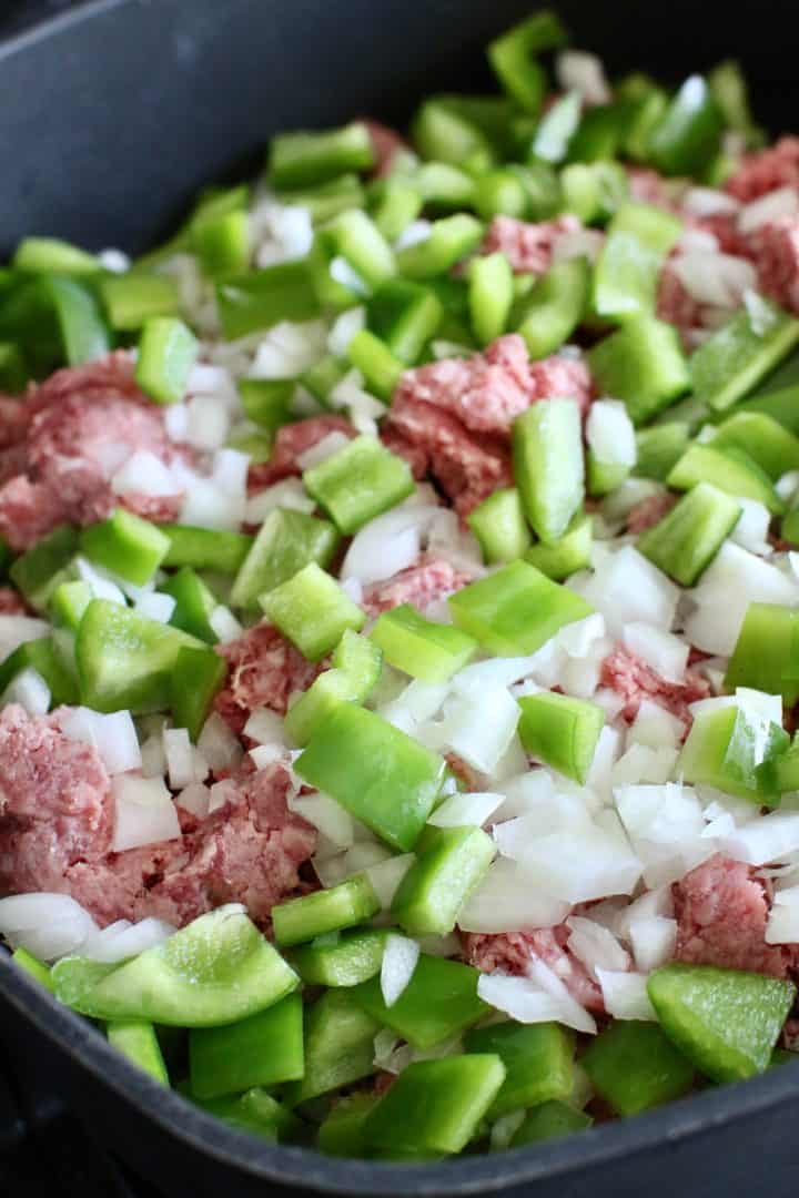 ground beef, diced green peppers and diced onion in a large skillet.