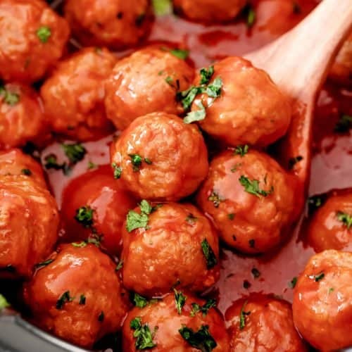 Close up of Crock Pot Meatloaf Meatball Recipe with serving spoon in crock pot