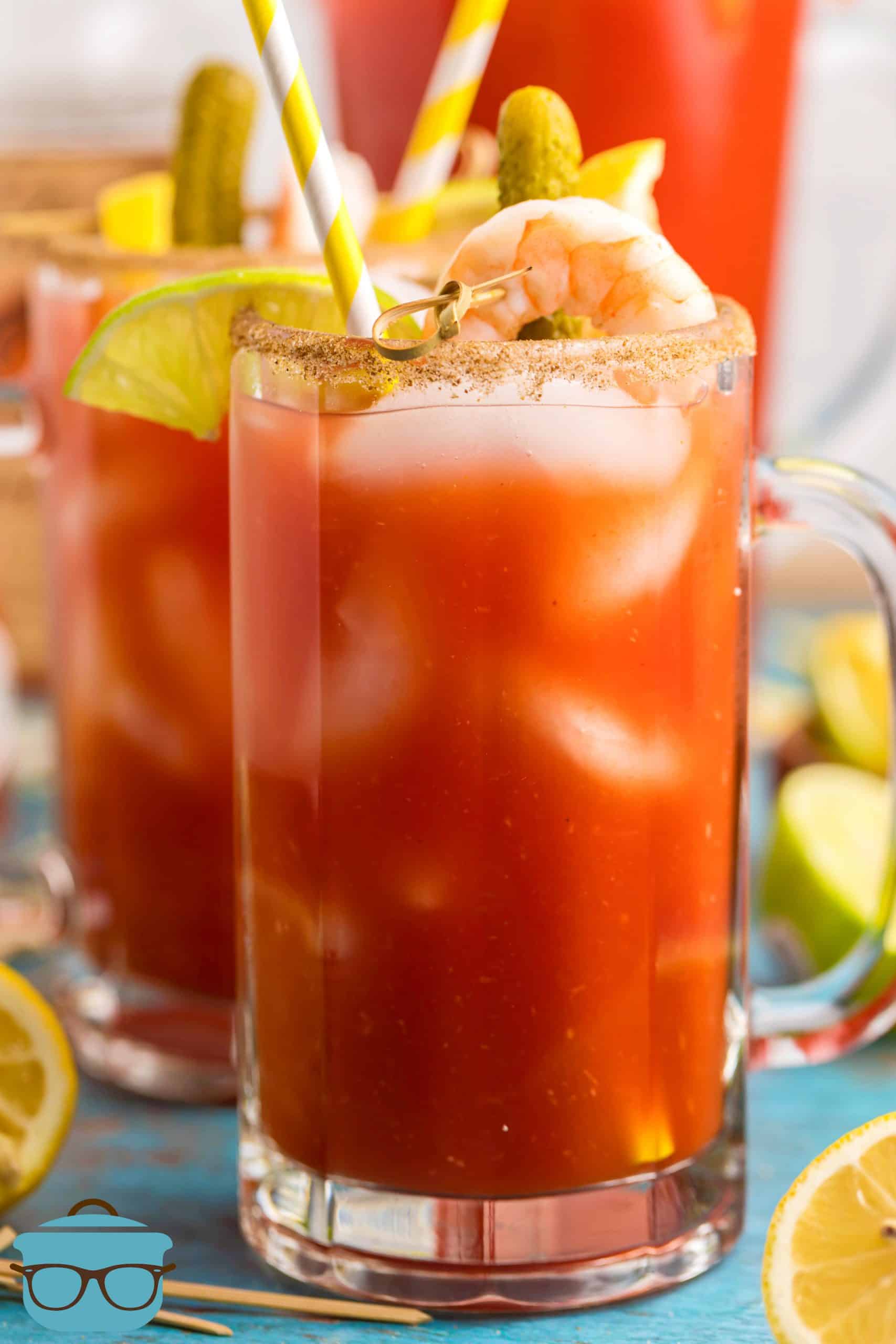 Bloody Mary Mix in tall glass with alcohol and garnishes.