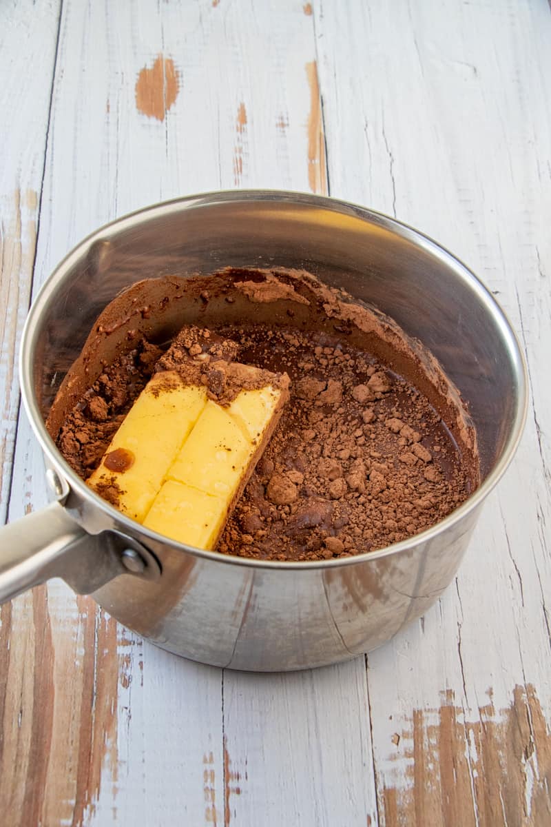 Margarine, water and cocoa powder added to metal sauce pan.