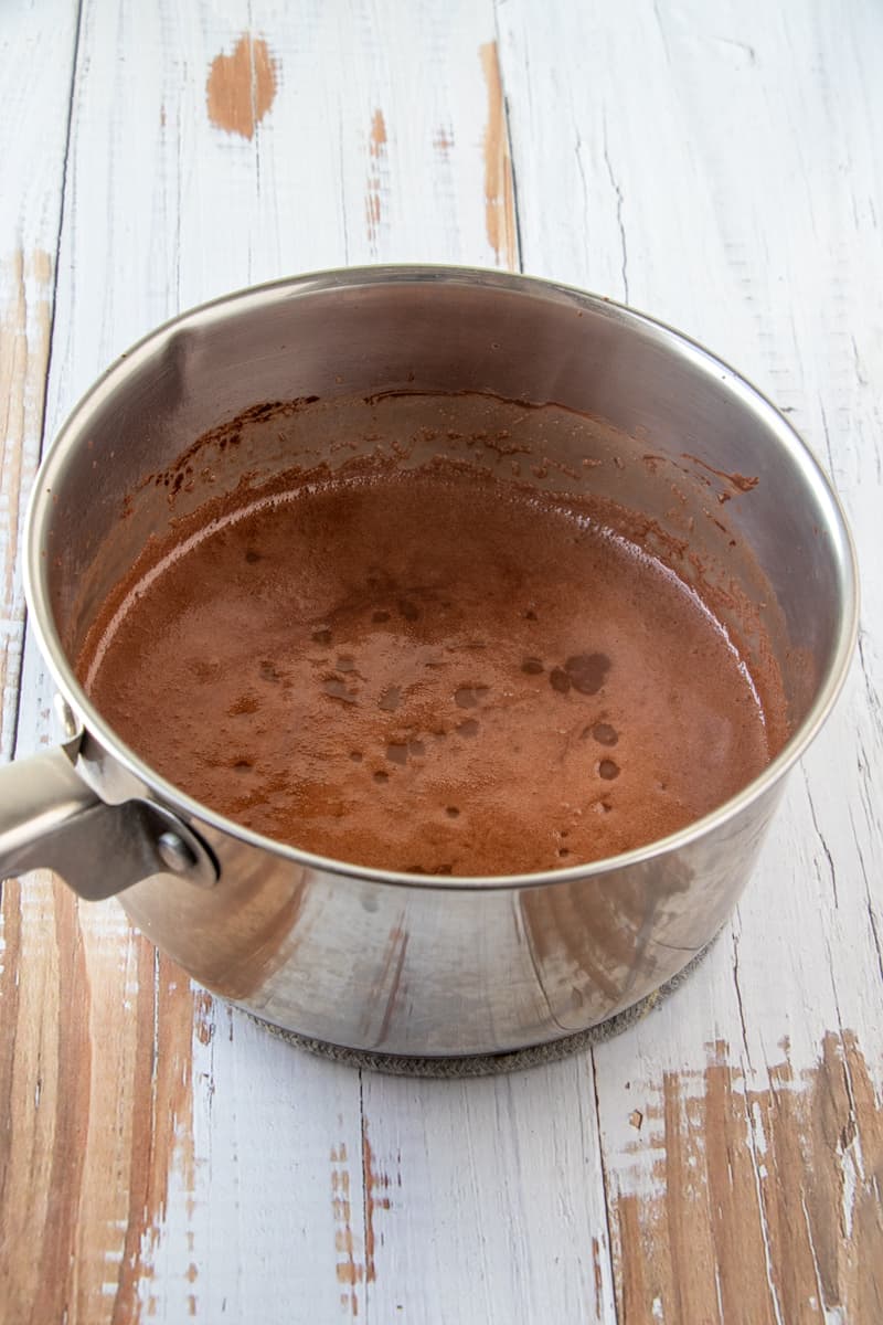 Melted butter, water and cocoa powder mixture in metal pot.