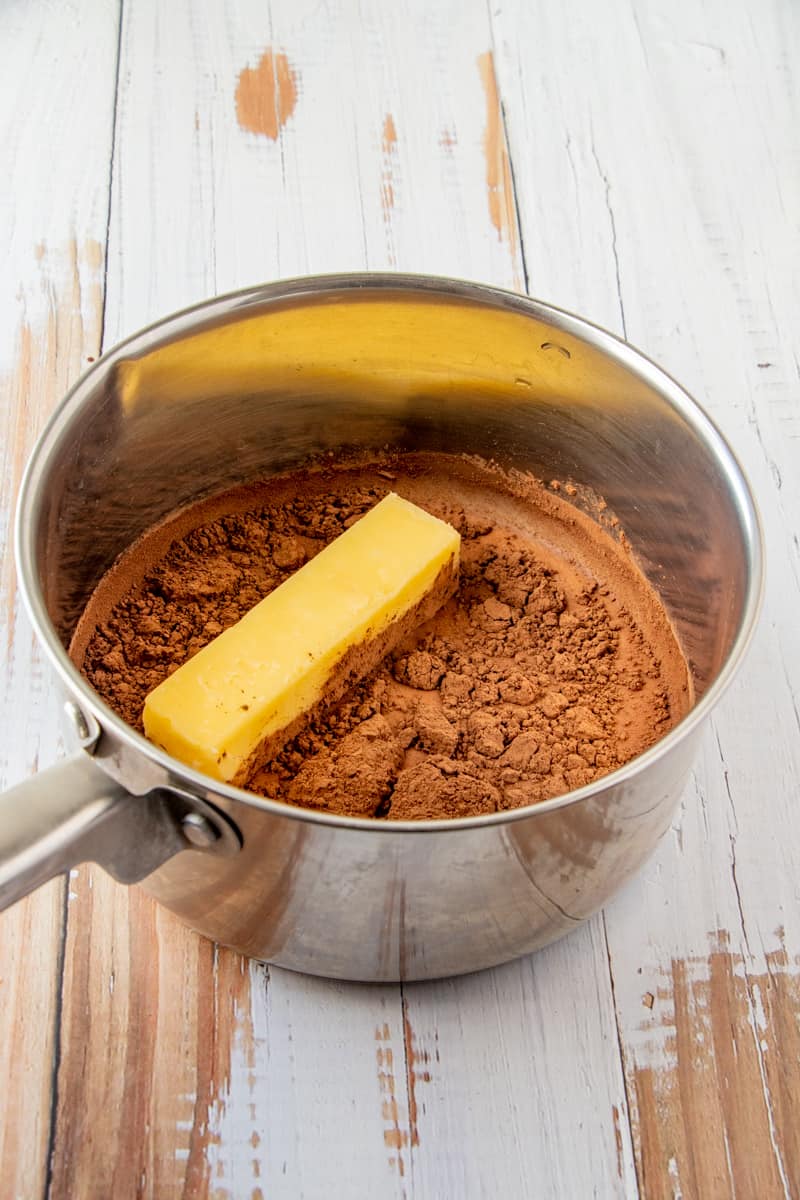 Margarine, milk and cocoa powder added to metal sauce pan.