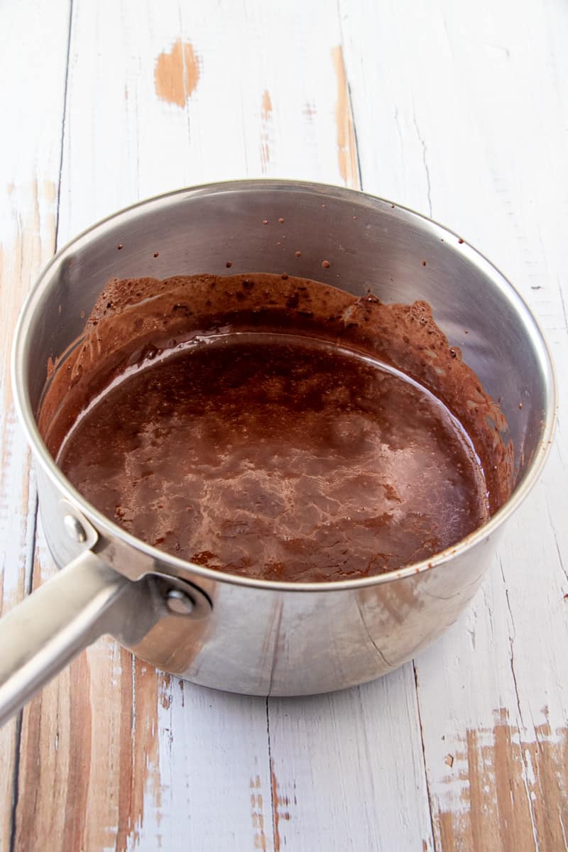 Melted butter, milk and cocoa mixture in metal sauce pan.
