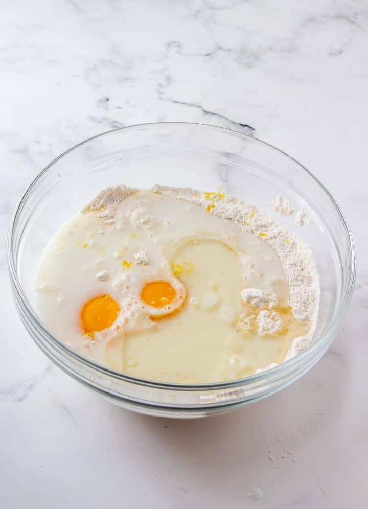 Eggs and wet ingredients added to bowl.