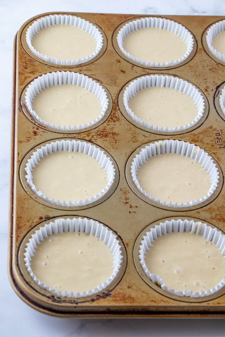 Batter added to cupcake liners.