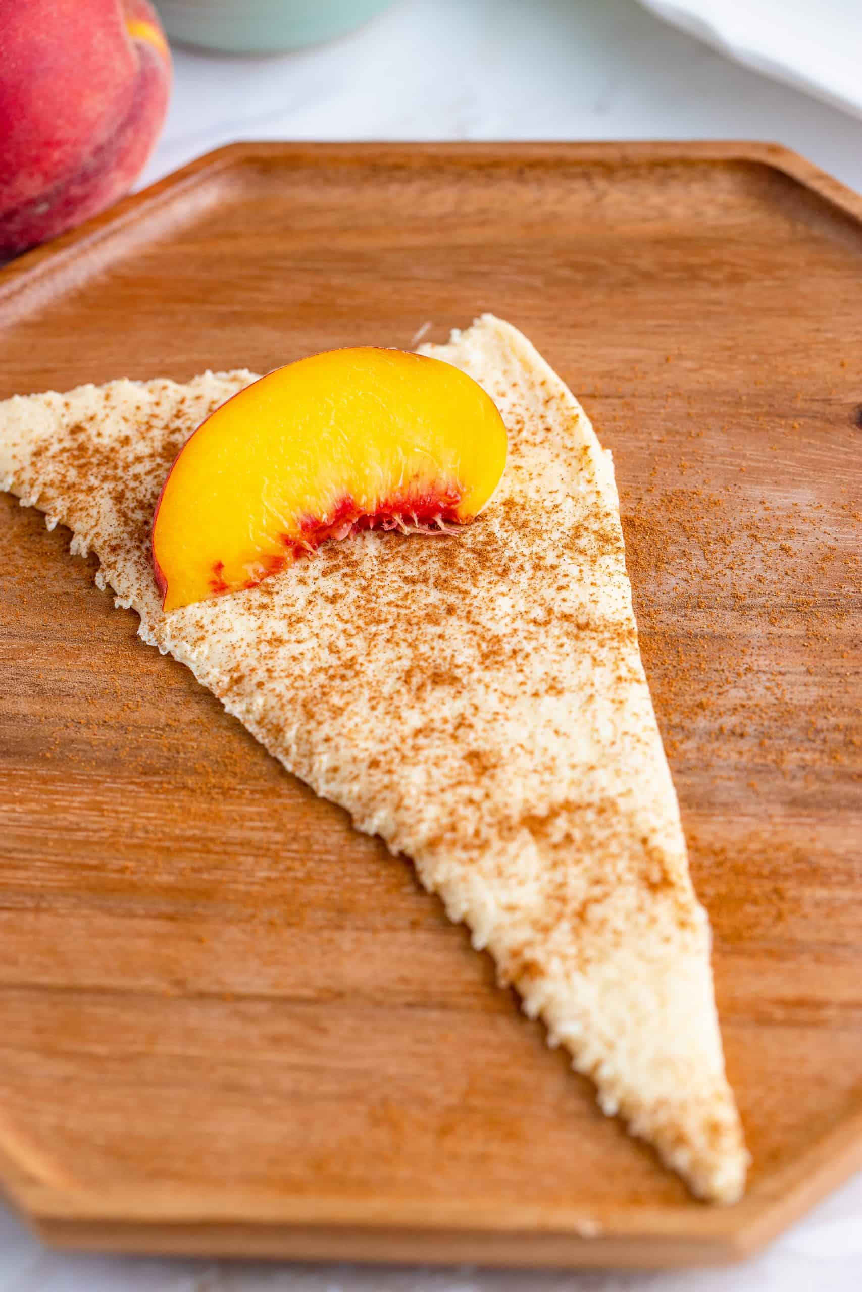 Peach slice at end of crescent roll.