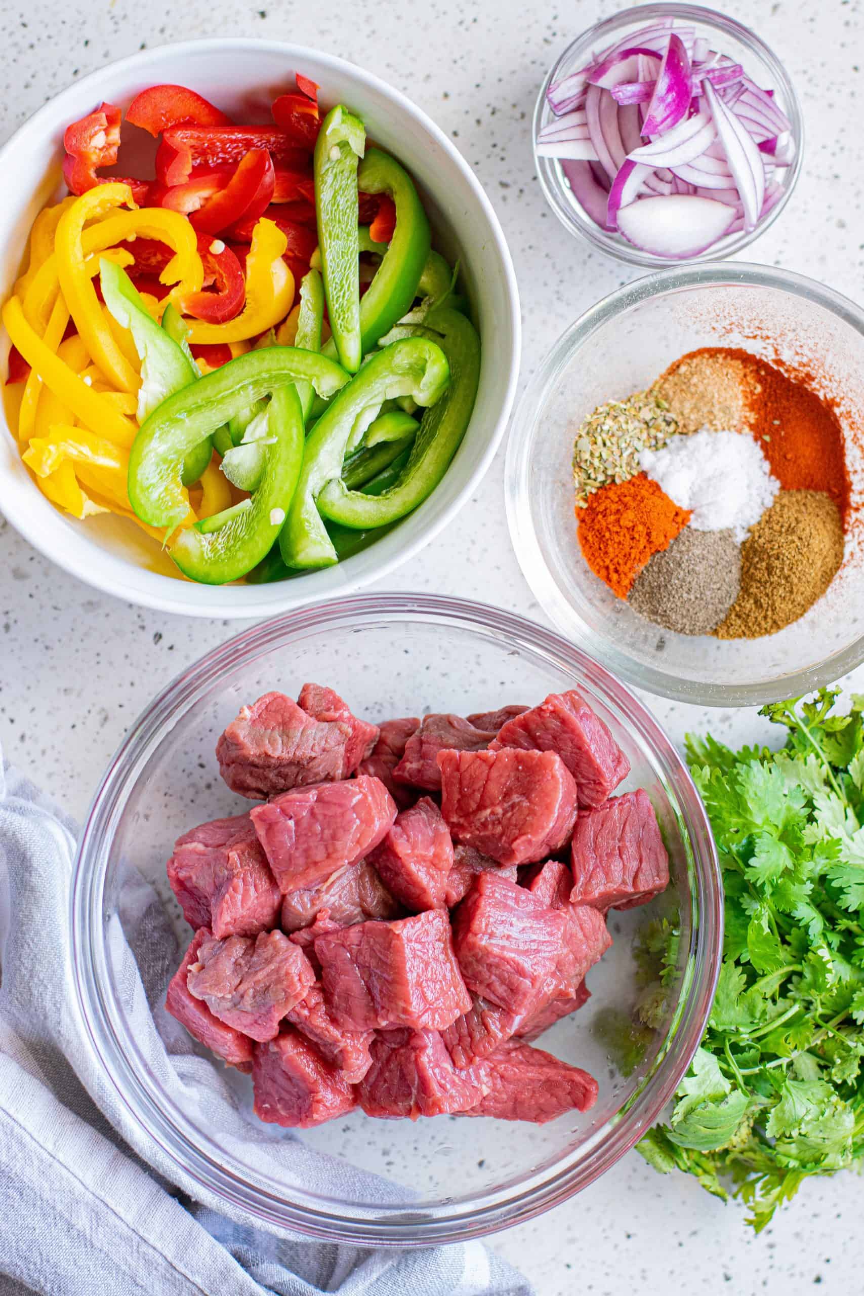 Ingredients needed steak, chili powder, garlic powder, smoked paprika, ground cumin, dried oregano, sea salt, black pepper, olive oil, red onion and bell peppers.