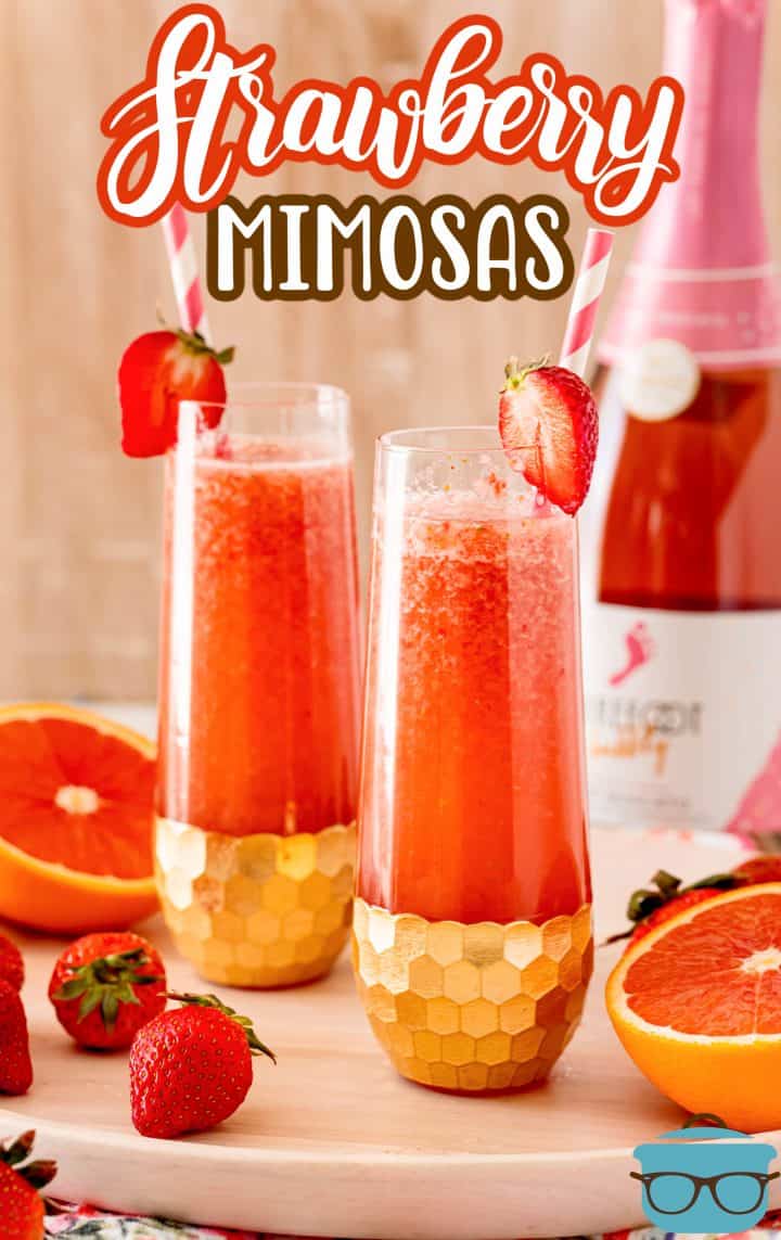 Pinterest image of two glasses of Strawberry Mimosas with prosecco in background.