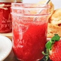 Square image of Strawberry Rhubarb Jam Recipe in jar with spoon