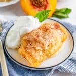 Square image of Easy Fresh Peach Dumplings with whipped cream and mint