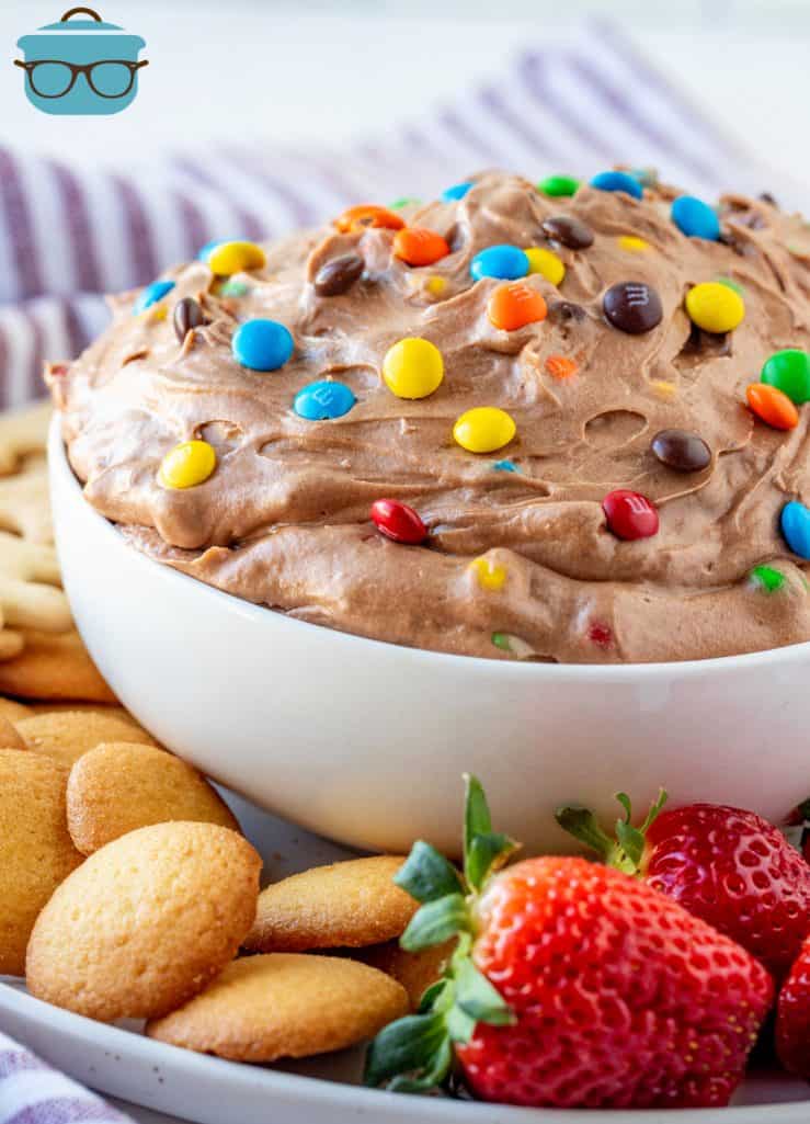 M&M Brownie Batter Dip in bowl surrounded by fruit and cookies