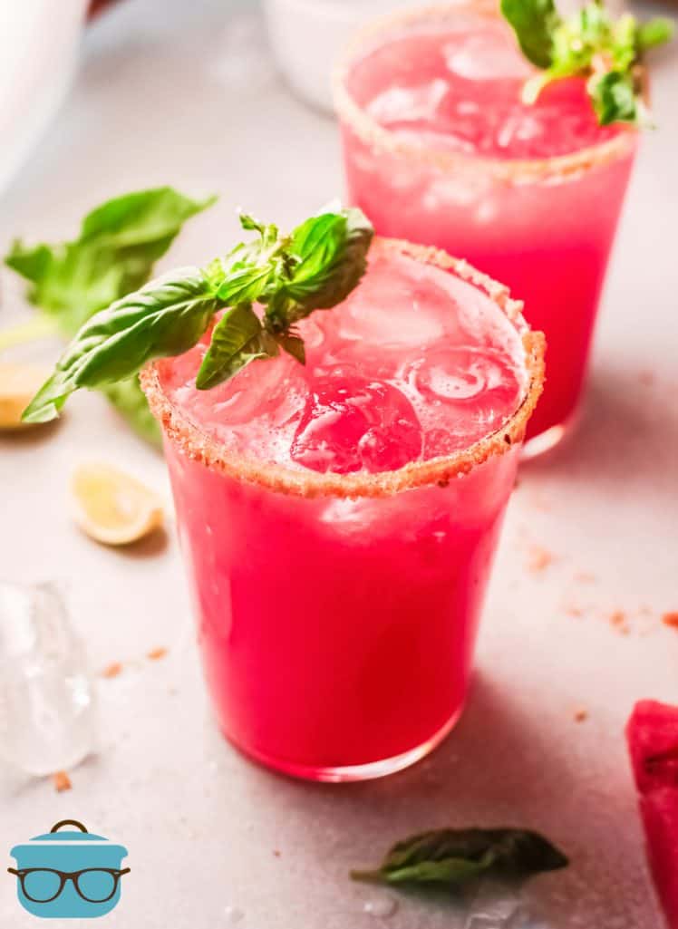 Two glasses of Watermelon Margaritas garnished with basil