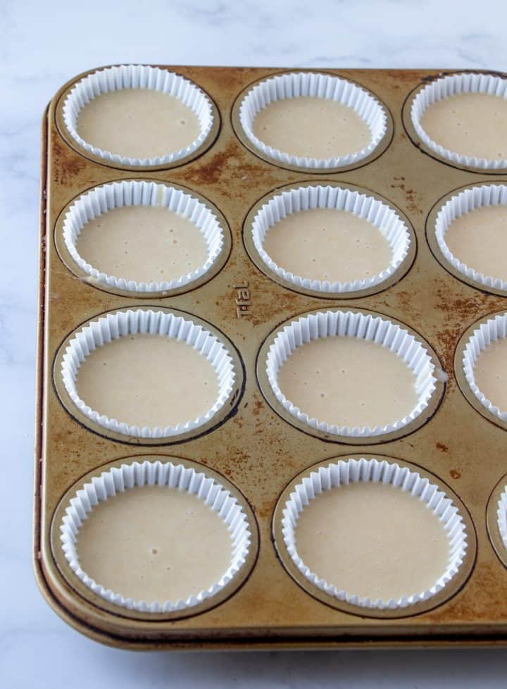 Cupcake liners filled with cupcake batter.