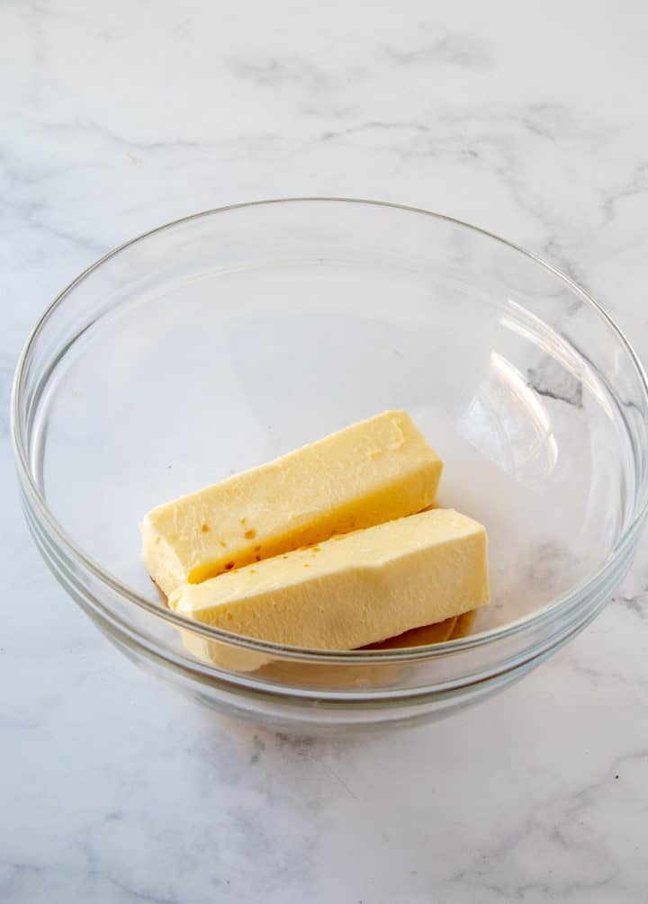 Butter and vanilla added to a clear bowl.