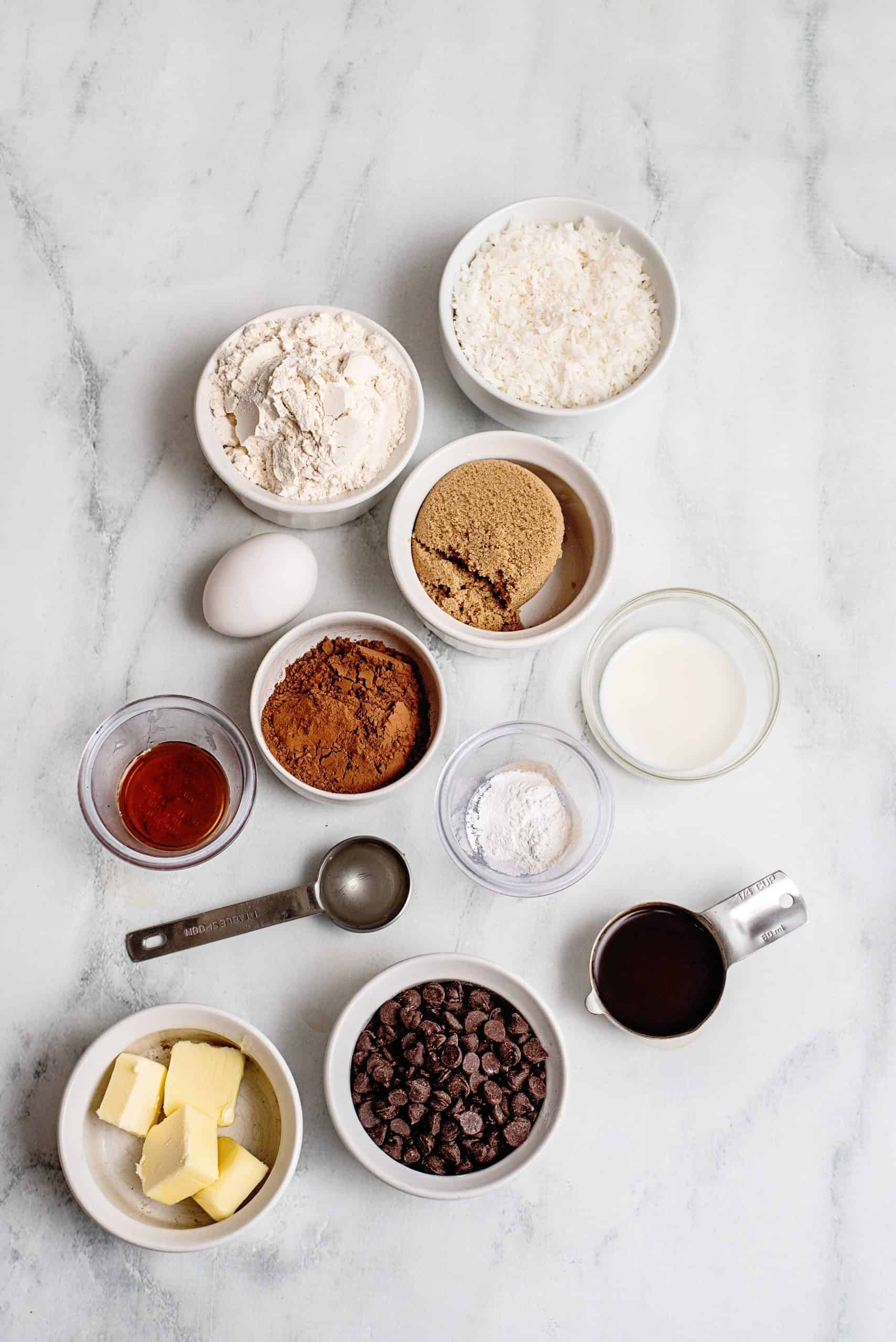 Ingredients needed: all purpose flour, unsweetened cocoa powder, baking powder, salt, light brown sugar, unsalted butter, egg , milk, hot coffee, vanilla extract, semisweet chocolate chips, light corn syrup and sweetened shredded coconut