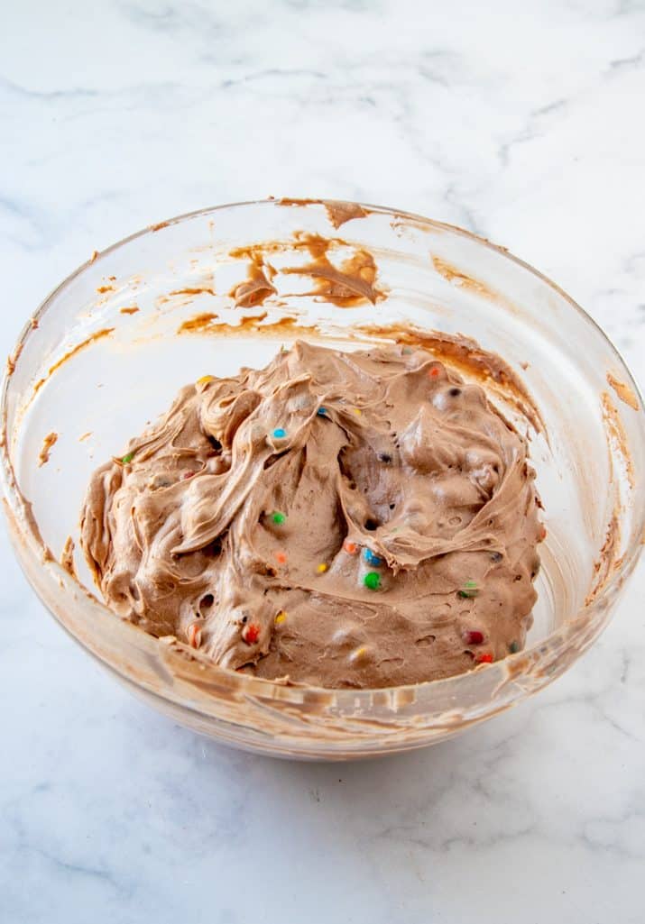 Finished M&M Brownie Batter Dip in clear bowl