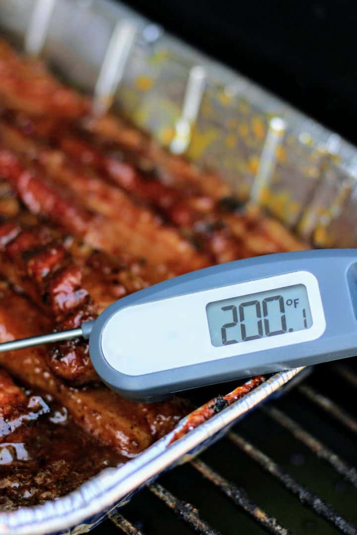 Thermometer checking the internal temperature of the pork belly