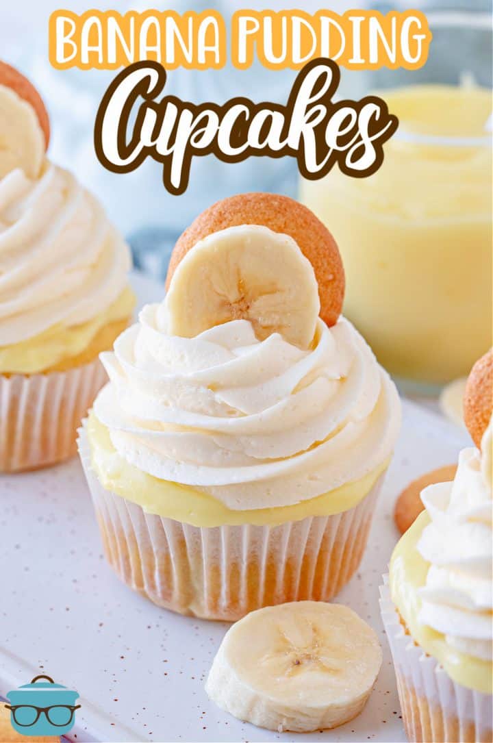 Banana Pudding Cupcakes on white tray with frosting, banana and vanilla wafer Pinterest image.
