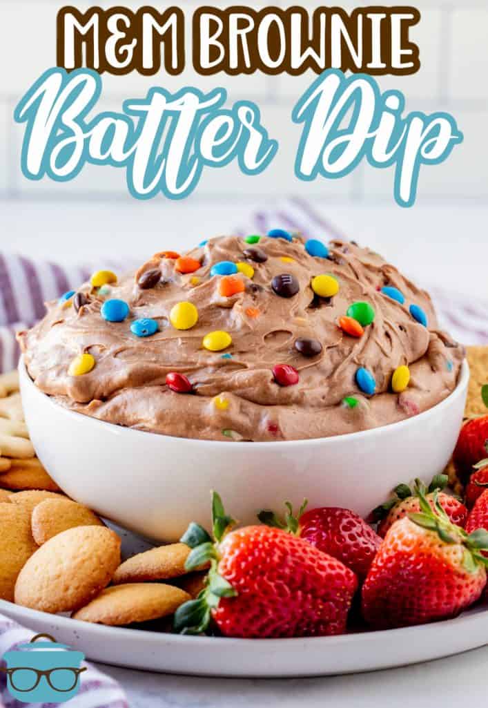 White bowl of M&M Brownie Batter Dip on platter with fruit and cookies Pinterest image