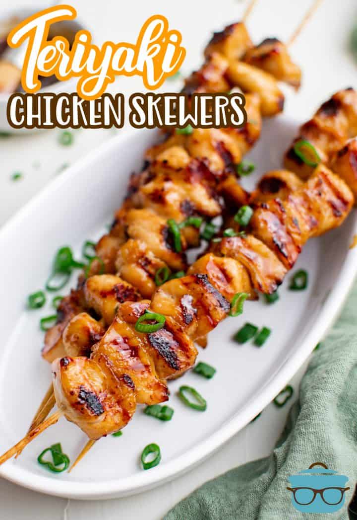 Stacked Teriyaki Chicken Skewers on white platter with green onions Pinterest image