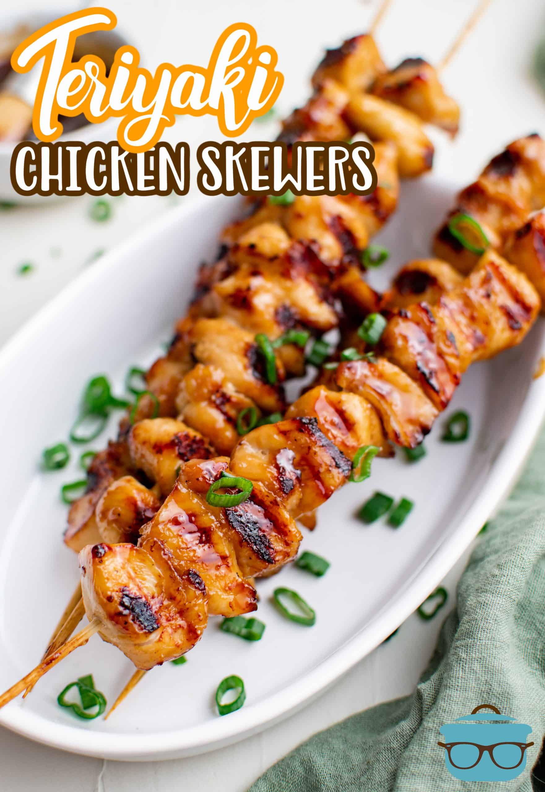 Stacked Teriyaki Chicken Skewers on white platter with green onions Pinterest image.