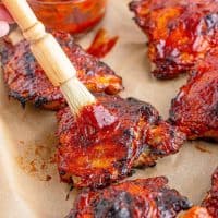 Close up of Homemade BBQ Sauce recipe basting chicken on pan