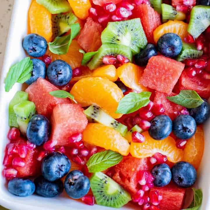 Overhead square image of The Best Fruit Salad all glazed and garnished with mint leaves Pinterest image