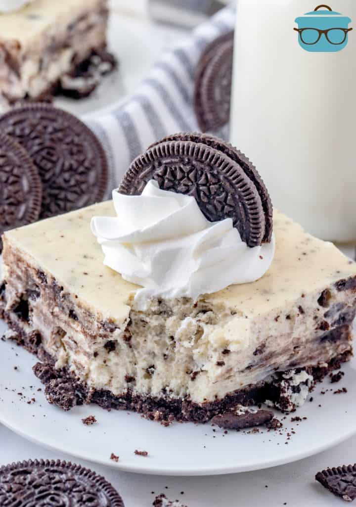 One Oreo Cheesecake Bar on plate with bite taken out.