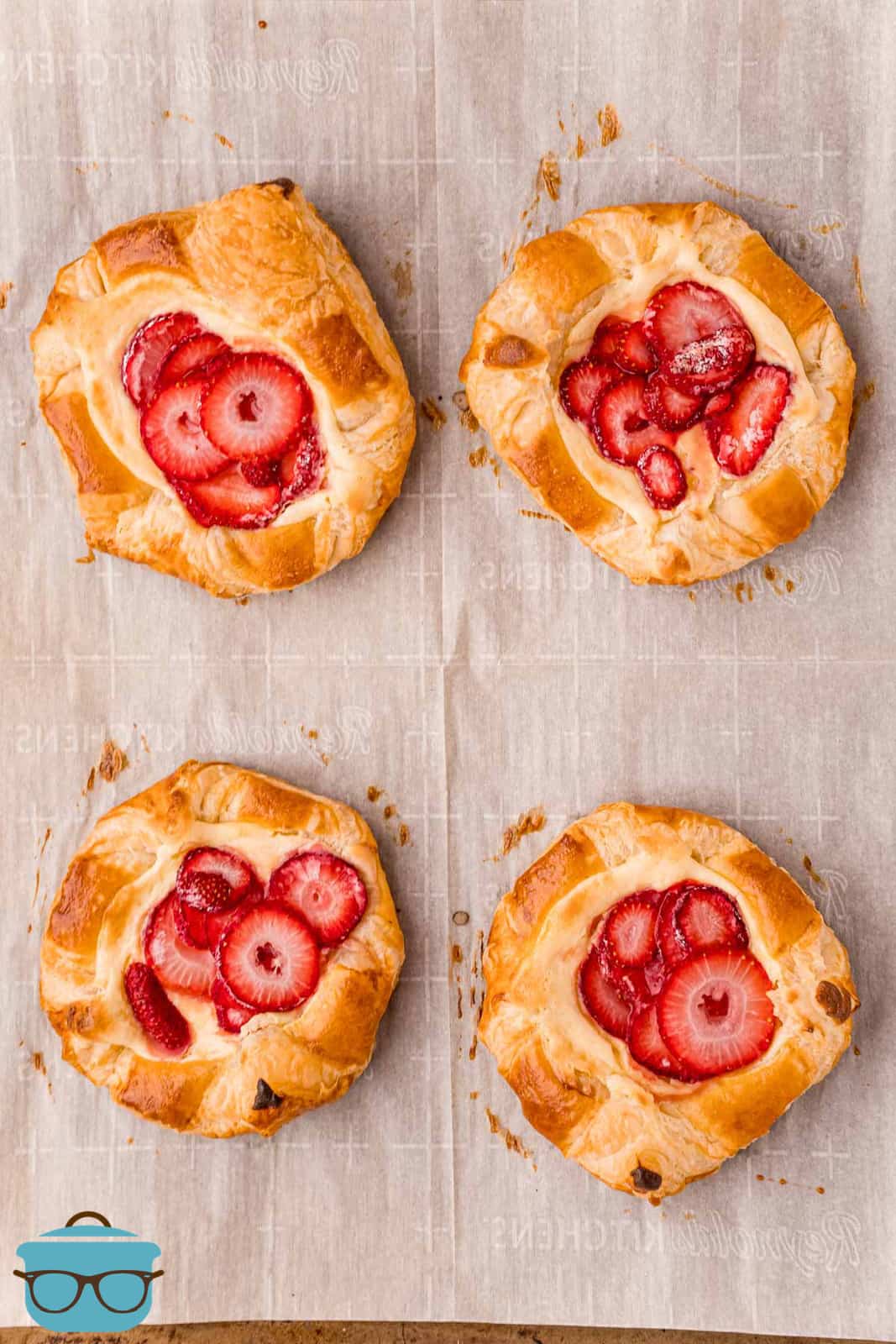 Finished Strawberry Cheese Danishes on parchment paper