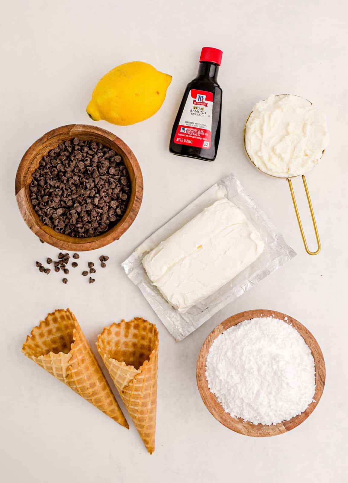 Ingredients needed: cream cheese,  ricotta cheese,  powdered sugar, almond extract,  lemon zest,  mini chocolate chips  and waffle cones.