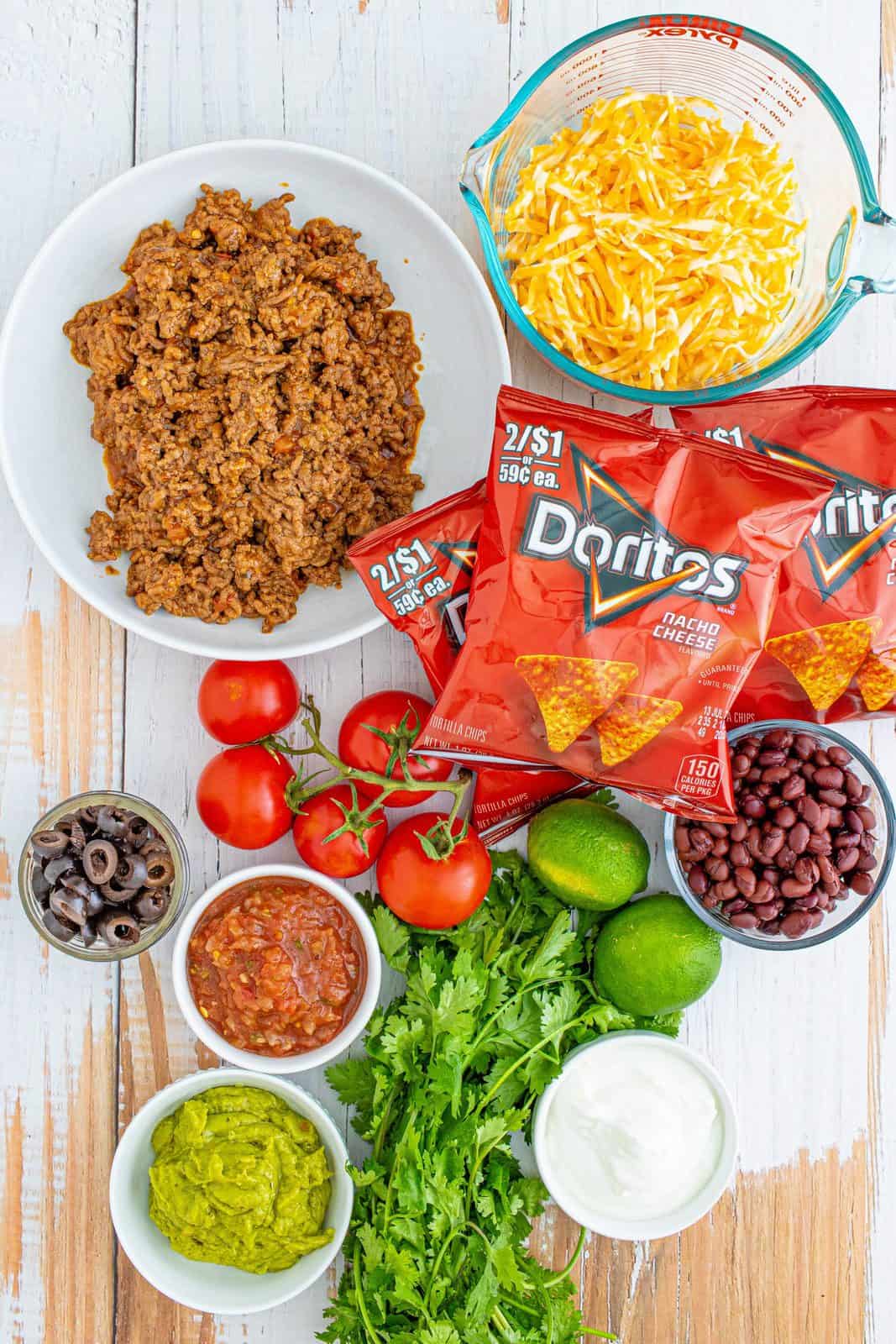 Ingredients needed: Doritos, seasoned taco meat, black beans, Colby Jack cheese and your Favorite Taco Toppings