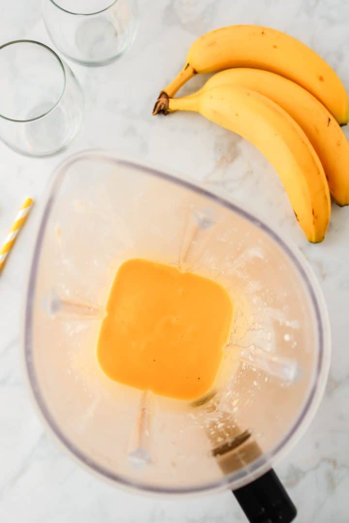 overhead photo showing mango smoothie fully blended in blender.