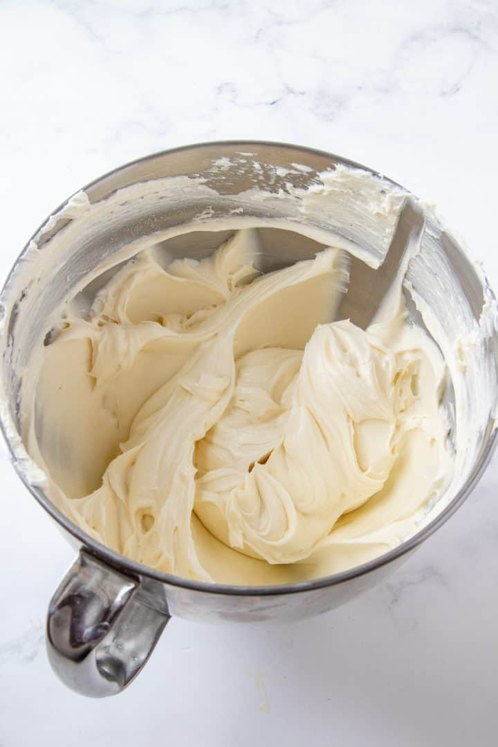 overhead photo of whipped cream cheese mixture in a silver mixing bowl