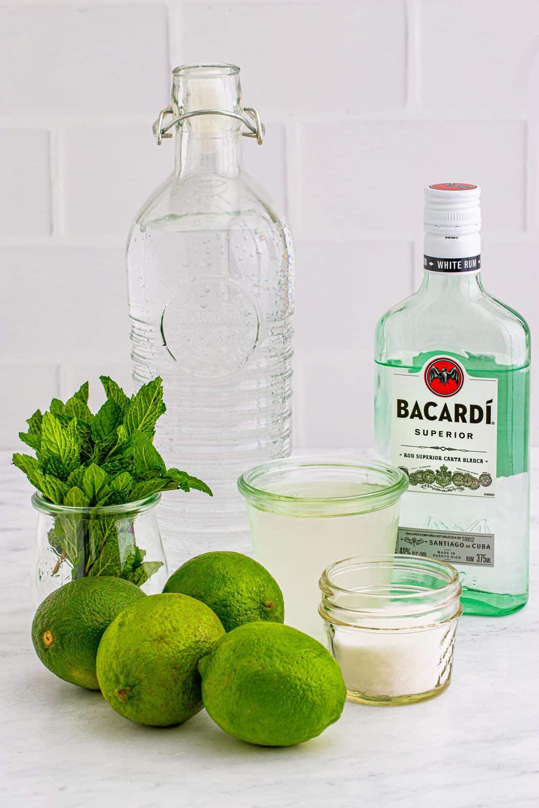 Ingredients needed: limes, mint, granulated sugar, simple syrup, white rum, club soda and ice.