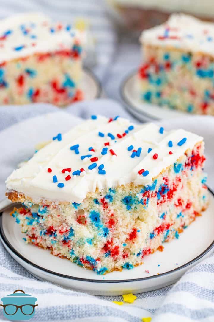 Bite taken out of one slice of Patriotic Homemade Funfetti Cake